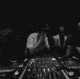 a black and white photo of a dj in front of a pioneer mixer