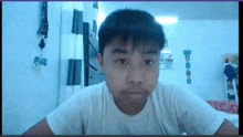 a boy in a white shirt is looking at the camera in front of a sign that says friday