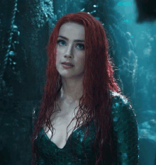 a woman with red hair wearing a green dress