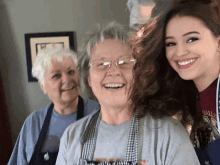 two older women and a younger woman are posing for a photo