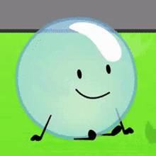 a cartoon character with a face and arms is sitting on a green field .