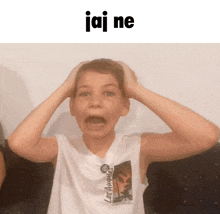 a boy wearing a los angeles tank top holds his head