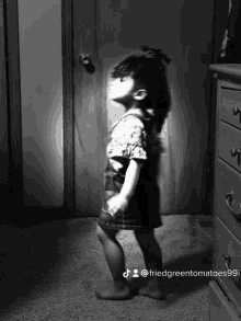 a black and white photo of a little girl with the hashtag friedgreentomatoes99 on the bottom