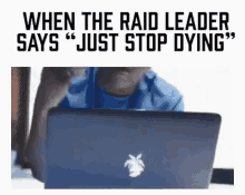 a man is sitting in front of a laptop computer and says `` just stop dying '' .