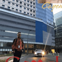 a man stands in front of a large building with the word cyper on it