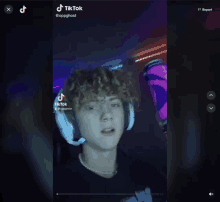 a tiktok video of a young man with headphones