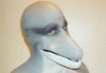 a close up of a person wearing a dolphin mask with a big nose and mouth .