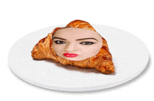 a white plate with a croissant with a woman 's face on it