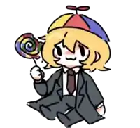 a boy in a suit and tie is holding a colorful lollipop .