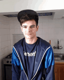 a young man wearing a black hat and a t-shirt that says ement