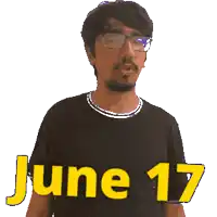 a man wearing glasses and a black shirt that says june 17 on it