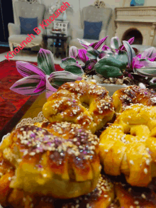 a bunch of bread with sesame seeds on it and the name khoaneh by khoaneh on the bottom