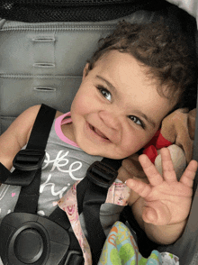 a baby in a stroller wearing a shirt that says " free " on it