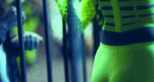 a blurred image of a person in a green superhero costume