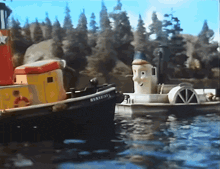 a toy tugboat with the name bentley on the side is in the water