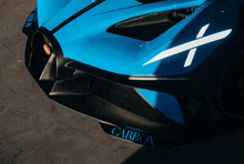 a close up of a blue car with the word carbon on the front