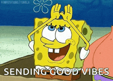 spongebob squarepants is smiling and giving a high five while sitting on the beach .