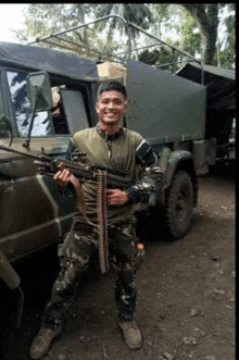 a man in a military uniform is holding a gun