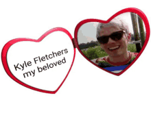 a red heart shaped mirror with kyle fletchers my beloved on it