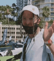 a man wearing a white hat and a mask stands in front of a building that says cruise on it