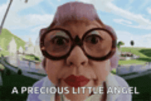 an elderly woman wearing glasses and a pink hat says " a precious little angel "