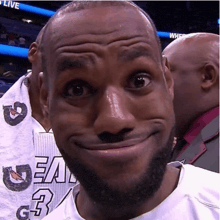 a man wearing a jersey with the number 3 on it makes a funny face