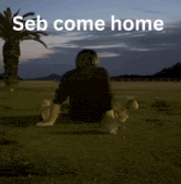 a man sits on the ground with two rabbits and the words seb come home written above him