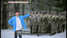 a man in a blue jacket stands in front of a military march