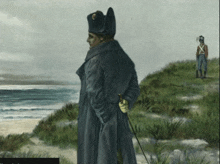 a painting of a man in a black coat standing on a hill near the ocean