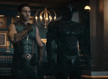 a man in a green superhero costume is standing in a room