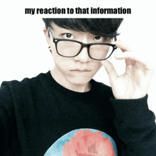 a man wearing glasses and a black shirt with the words my reaction to that information written above him