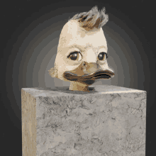 a statue of a duck with a mohawk on it