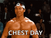 a man with a bandana on his head is standing in front of a crowd and says chest day
