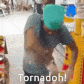 a man wearing a green hat is standing in front of a sign that says tornadoh !