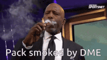 a man in a suit and tie smoking a cigar with the words pack smoked by dme above him