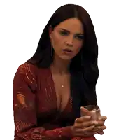 a woman in a red dress holds a glass in her hands