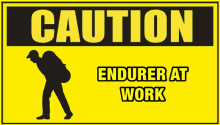 a caution sign that says " endurer at work "