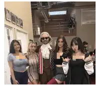 a man dressed as abraham lincoln poses for a picture with three women