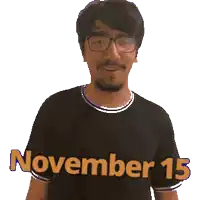 a man wearing glasses is wearing a black shirt that says november 15