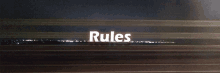 a sign that says rules on it with a dark background