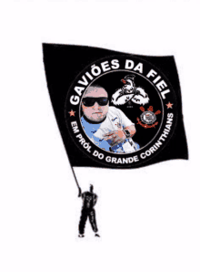 a man is holding a black flag with the words gavioes da fiel written on it