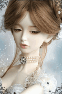 a doll wearing a white lace dress and a pearl choker