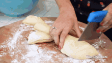 a woman is cutting a piece of dough on a cutting board with the words bigger healthy baking written on the bottom