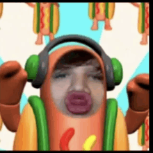 a man in a hot dog costume is wearing headphones and making a funny face .