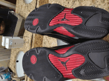 the bottom of a pair of black and red air jordan shoes