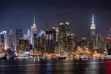 new york city skyline at night with the empire state building lit up