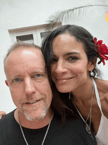 a man with a beard and a woman with a flower in her hair