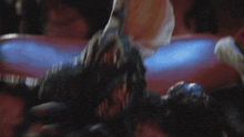 a close up of a gremlin holding a bag that says t8