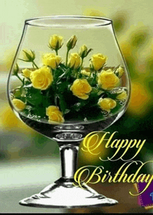 a birthday card with a glass filled with yellow roses and the words happy birthday