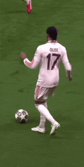 a soccer player with the number 17 on his back is being tackled by another player